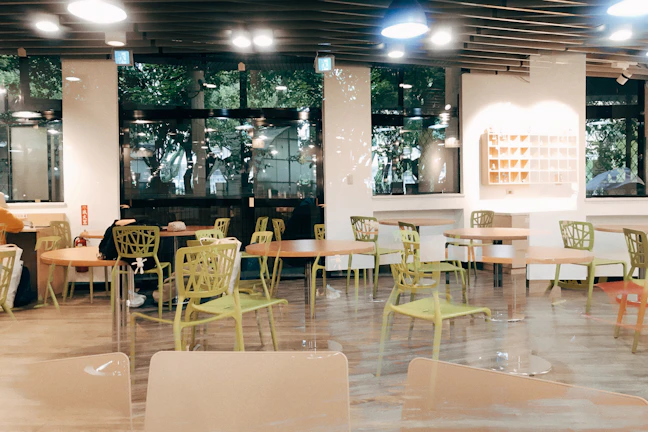 Interior view of the contemporary cafe dining area featuring glowing gold accents and luxurious seating.