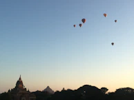 Close-up of a balloon basket with passengers marveling at the sunrise over Luxor’s temples.