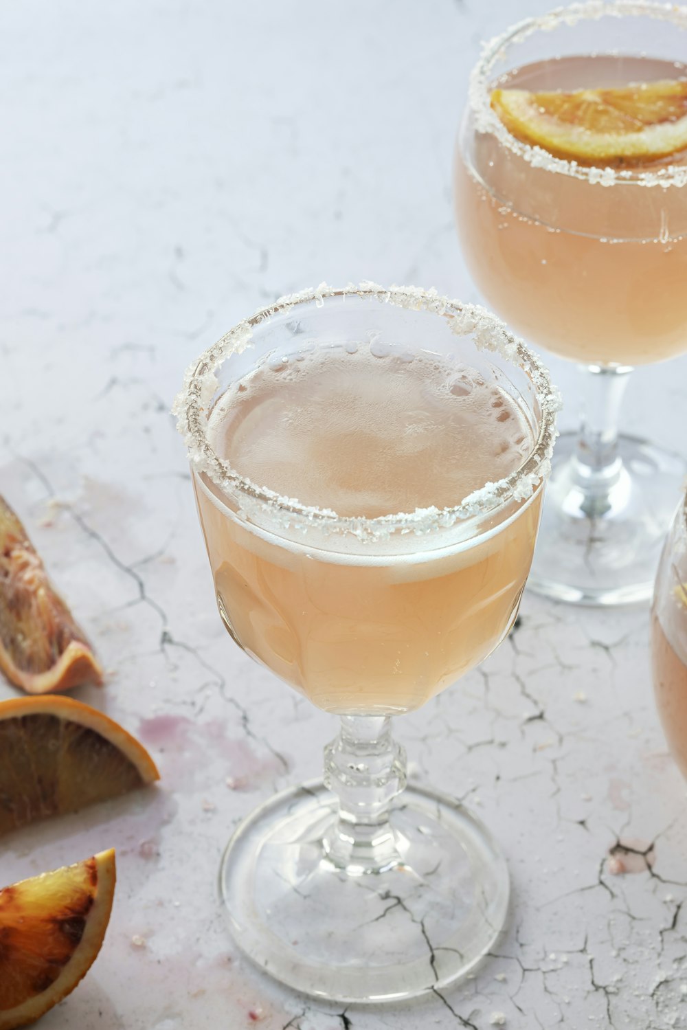 a couple of glasses filled with drinks on top of a table