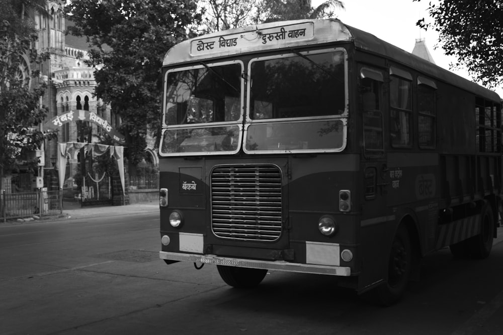 a black and white photo of a bus on a street