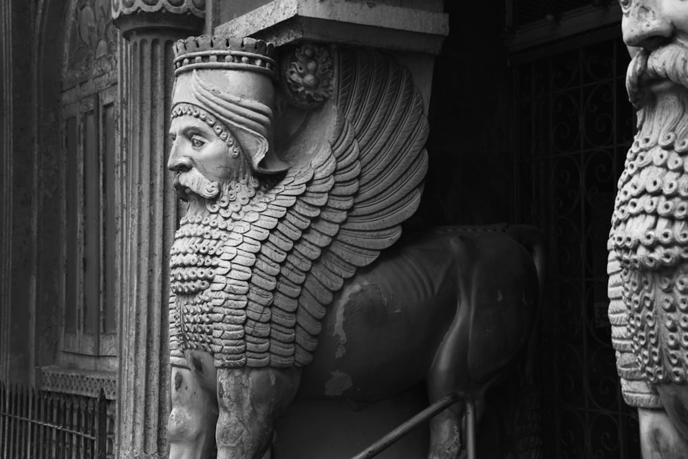 a black and white photo of a statue of an egyptian god