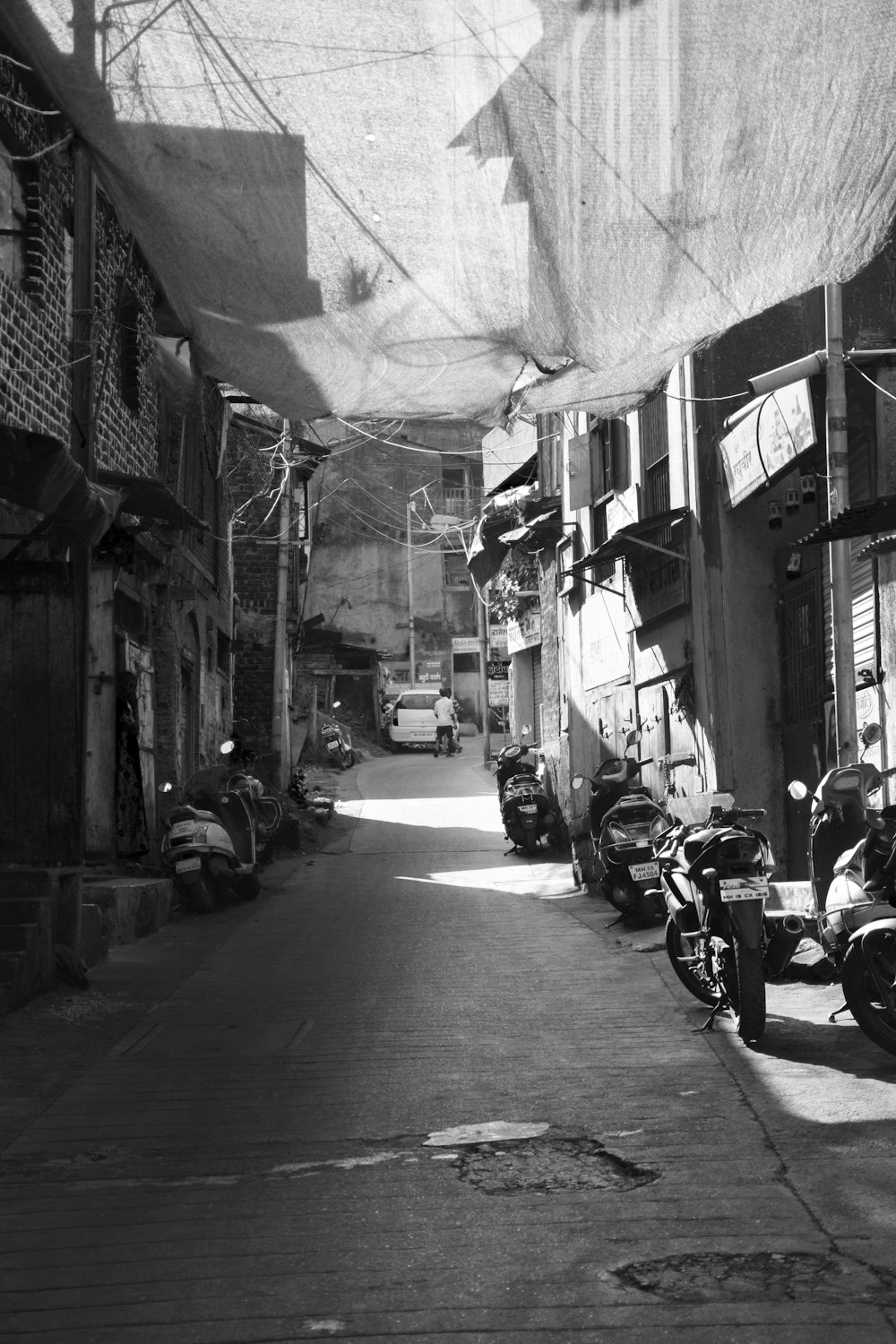 a black and white photo of a narrow street