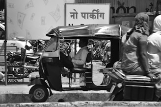 a tuk tuk driving down a busy street