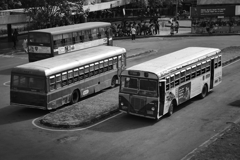 a couple of buses parked next to each other on a street