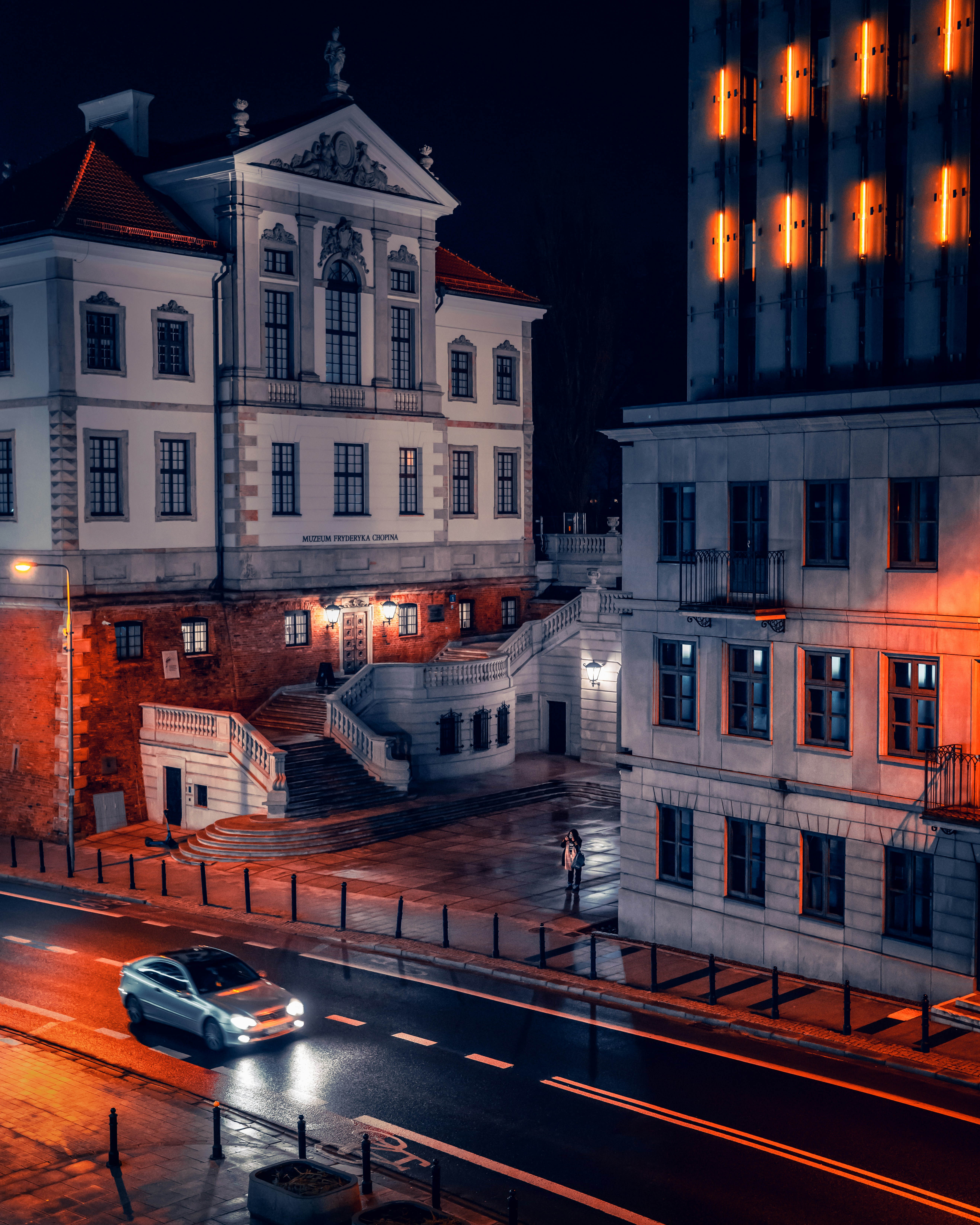 a car driving down a city street at night