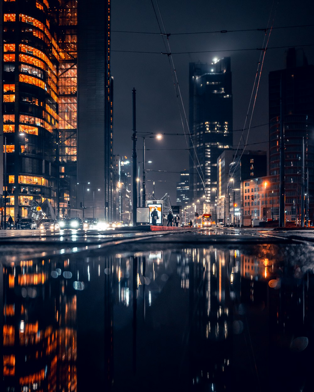 a city at night with a lot of lights reflecting in the water