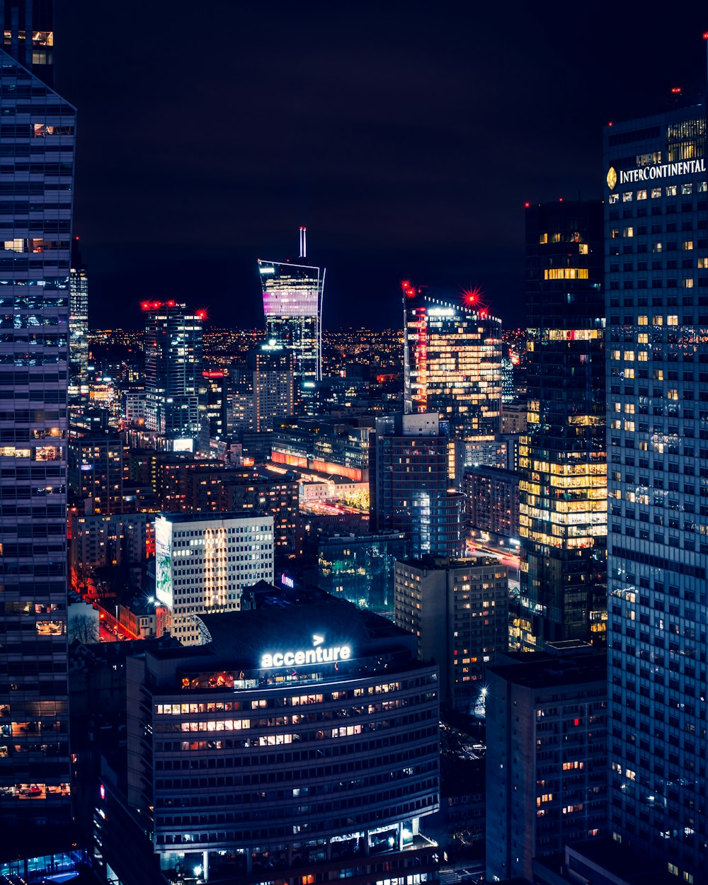 a night view of a city with tall buildings