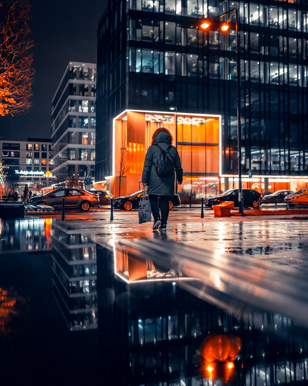 a person walking down a street at night