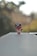 A small figurine with a red and black color scheme stands prominently on a flat, light-colored surface. The character is dressed in a doctor's coat and has a stethoscope. The background is blurred with bokeh effects, creating a serene and focused scene.