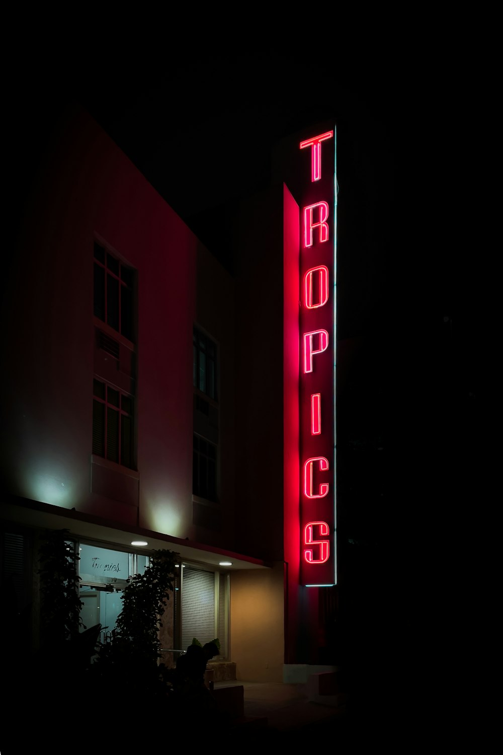 a sign lit up at night