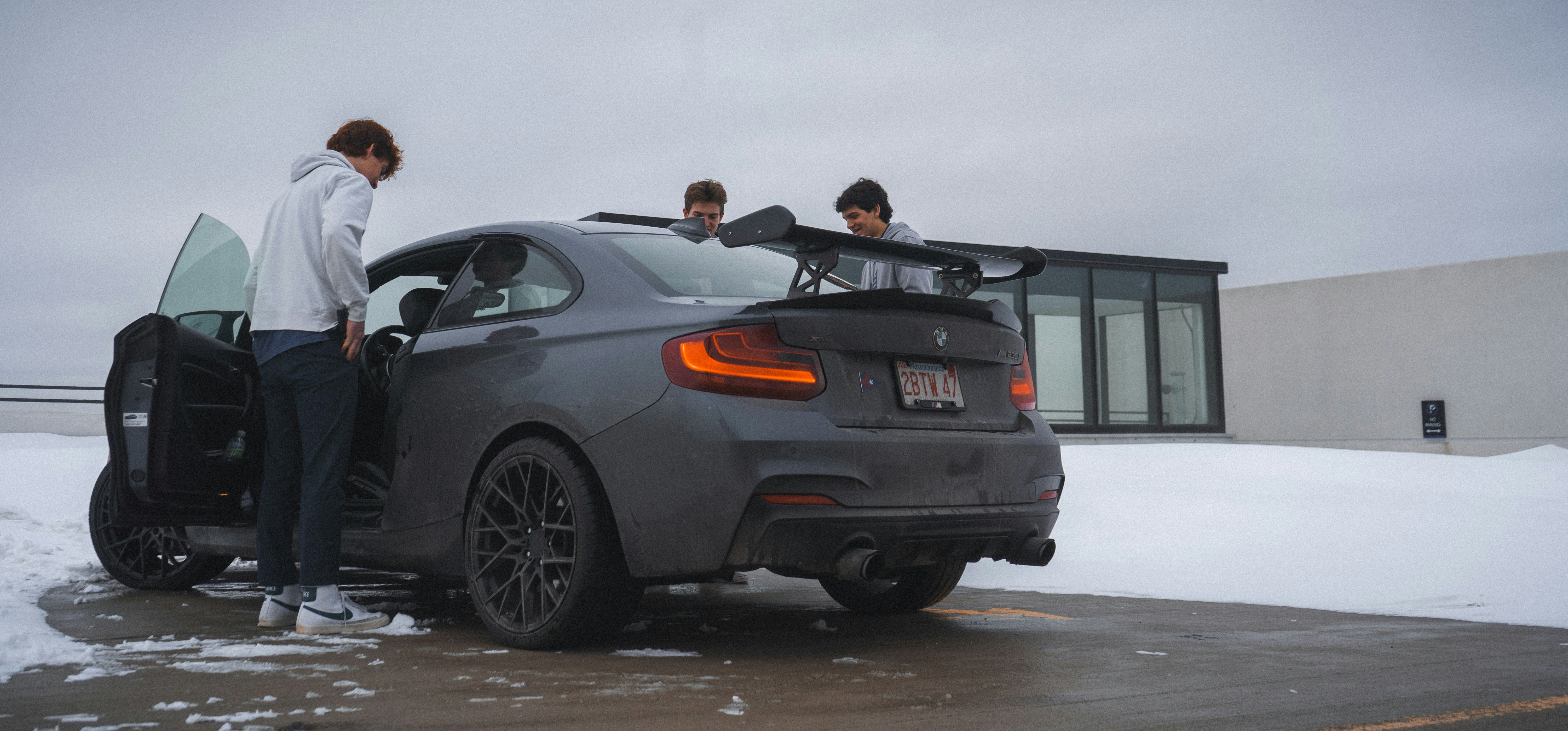 a couple of people standing next to a car