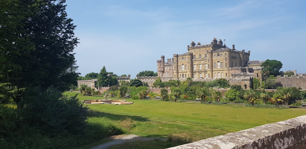 a large building sitting on top of a lush green field