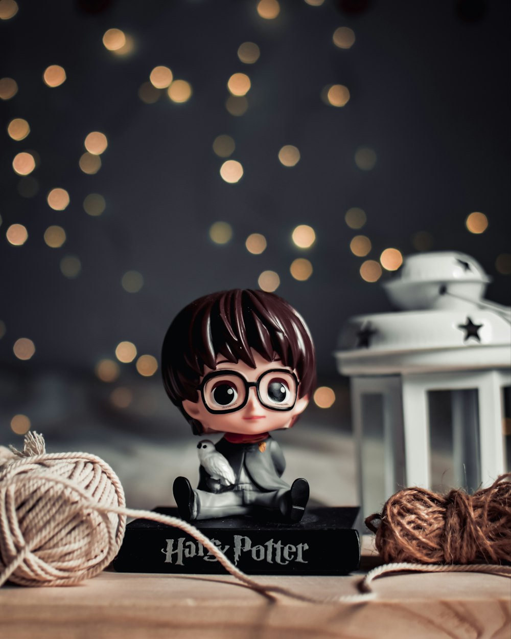 a harry potter figurine sitting on top of a book
