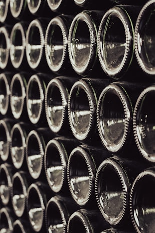 a bunch of wine bottles stacked on top of each other