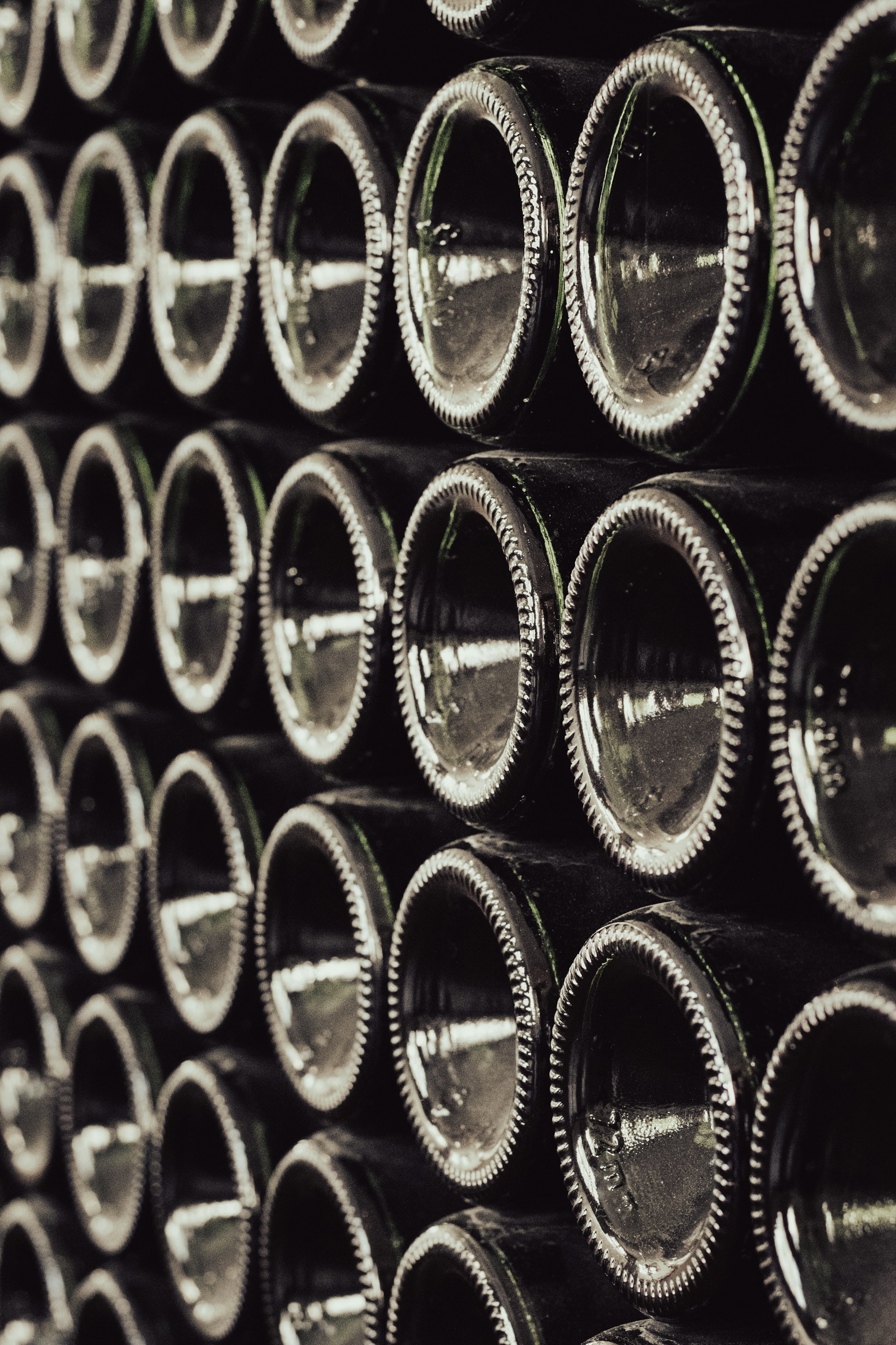 a bunch of wine bottles stacked on top of each other