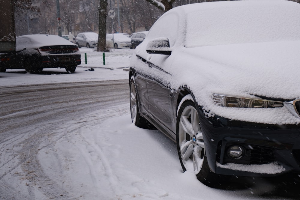 Un'auto coperta di neve su una strada innevata