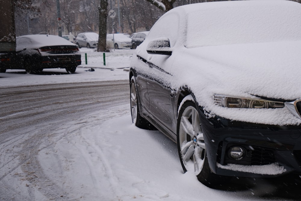 a car covered in snow on a snowy street