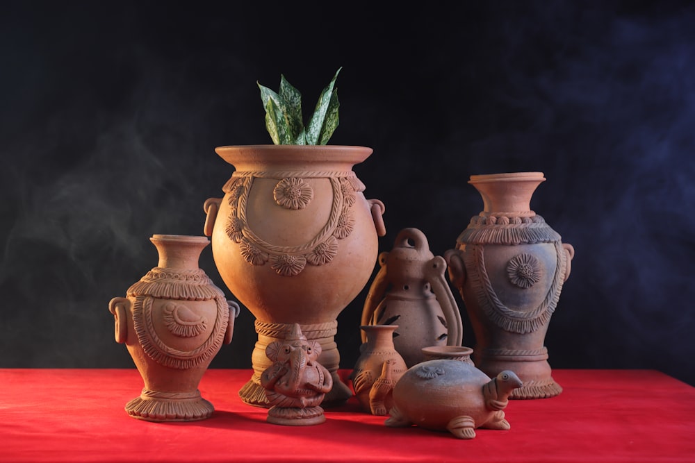 a group of vases sitting on top of a red table