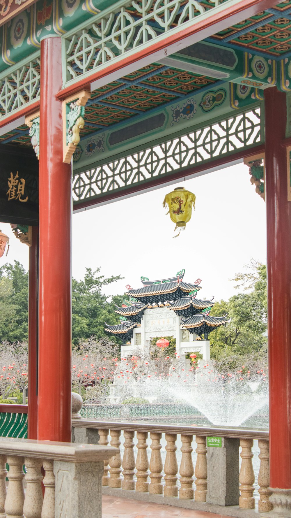 a chinese building with a fountain in front of it