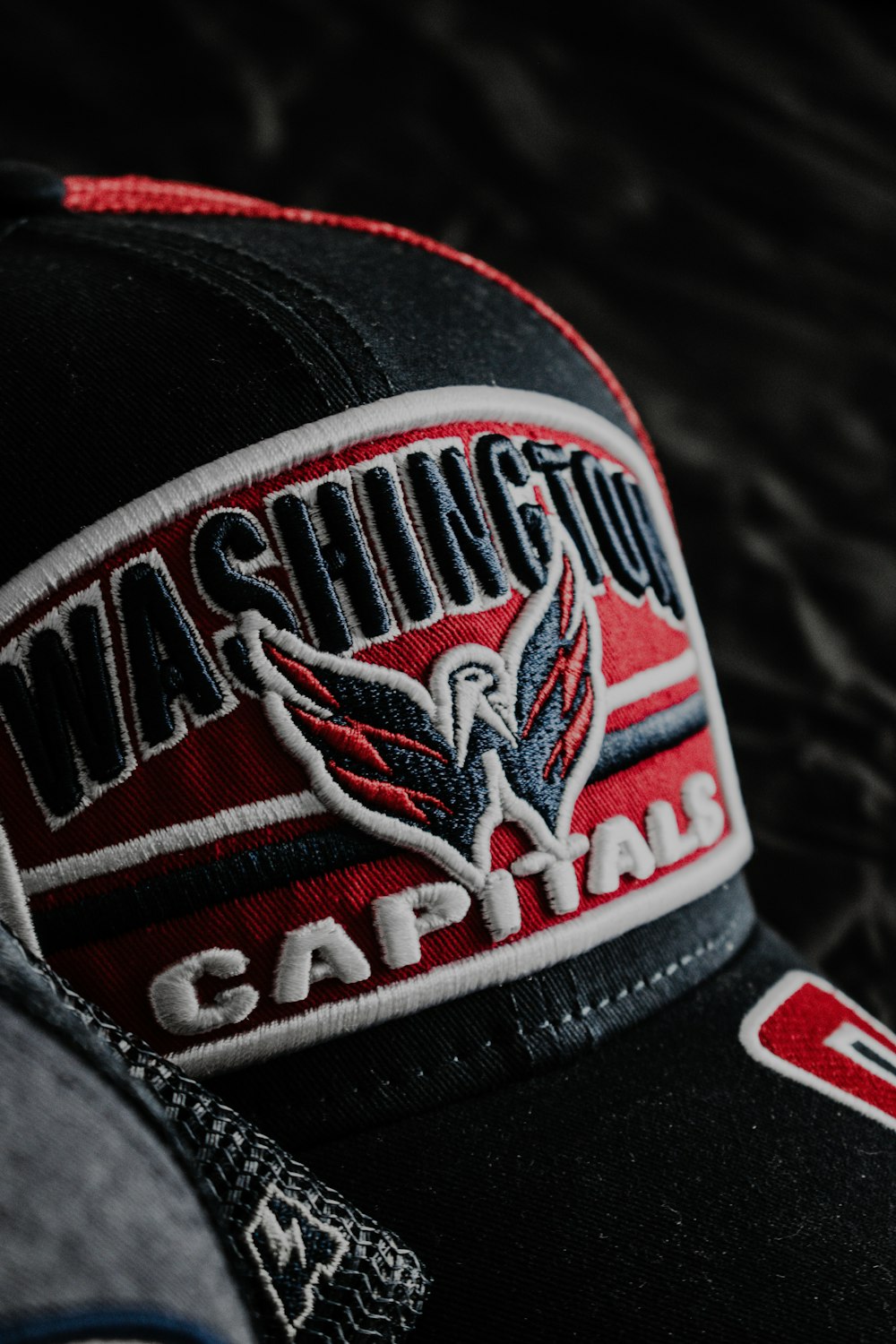 a black and red hat with washington capital on it