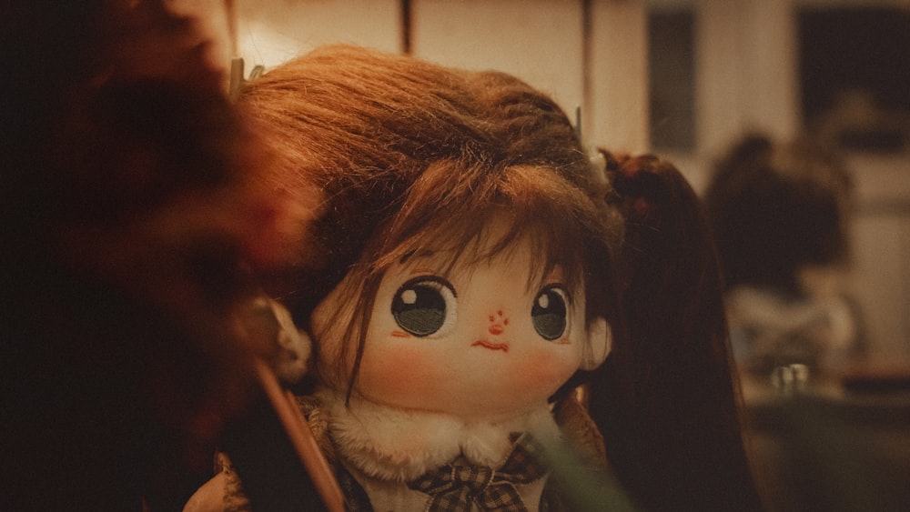a close up of a doll with long hair