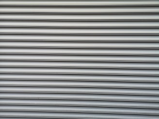 a red fire hydrant sitting on the side of a building