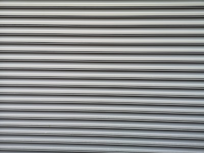 a red fire hydrant sitting on the side of a building