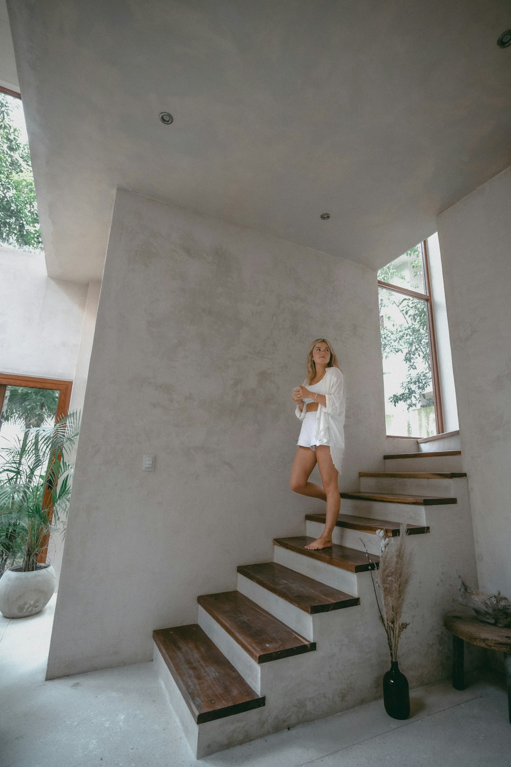 a woman standing on the stairs of a house