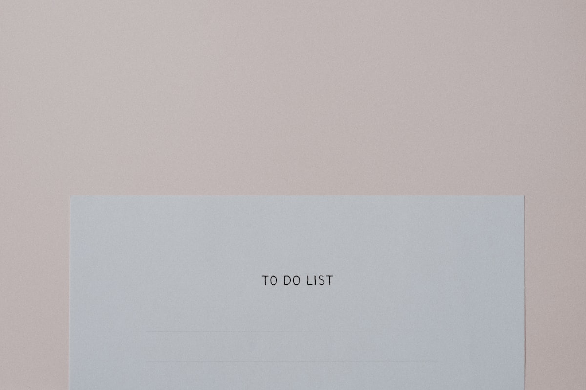 A top-down photo of a piece of paper with the words “to do list” written on it in block letters.