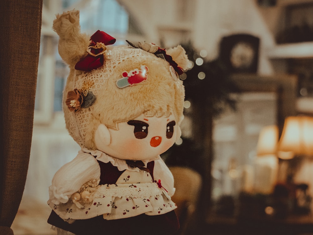 a stuffed animal doll with a dress and a bow