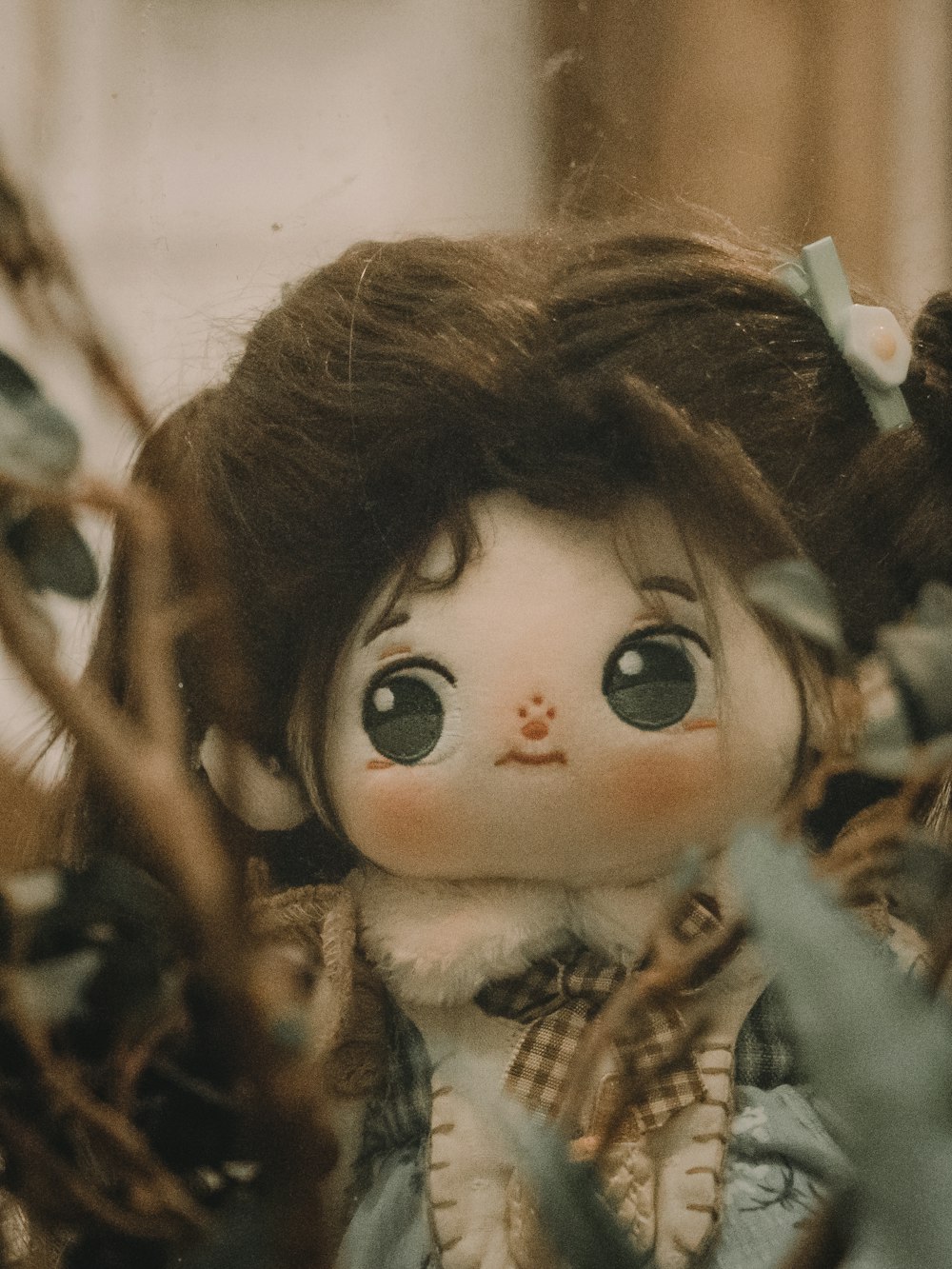 a close up of a doll in a tree