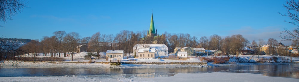 a church with a steeple on a snowy day