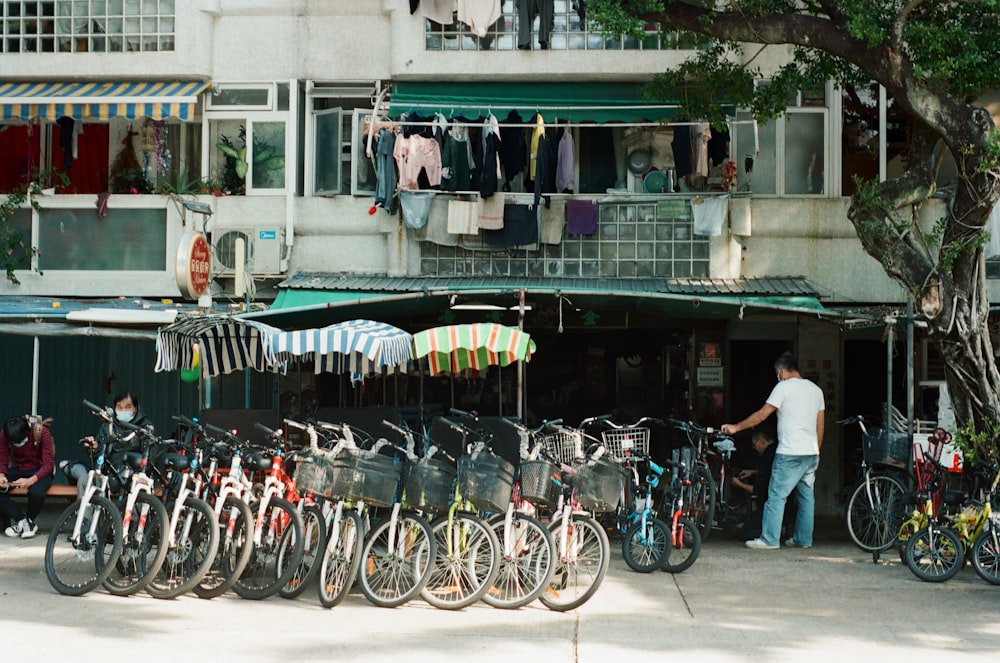 a bunch of bikes parked in front of a building