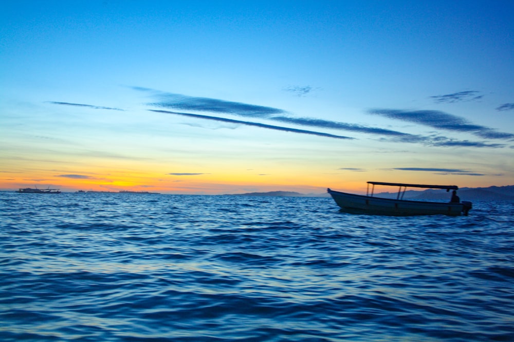 a boat floating on top of a large body of water