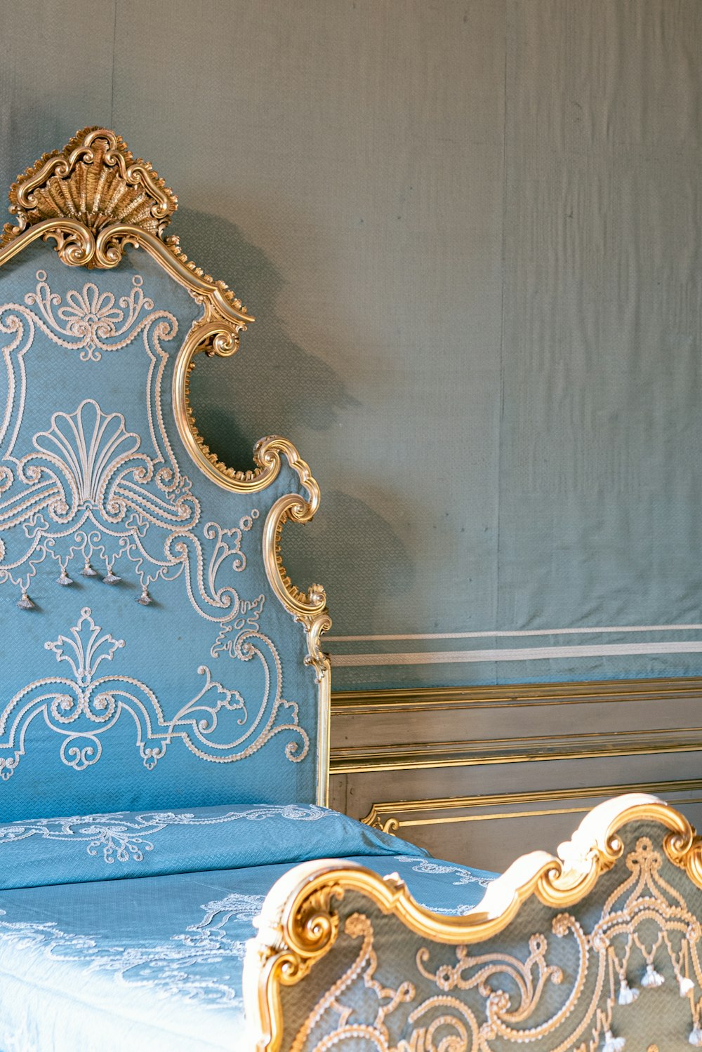 a gold and blue bed in a room