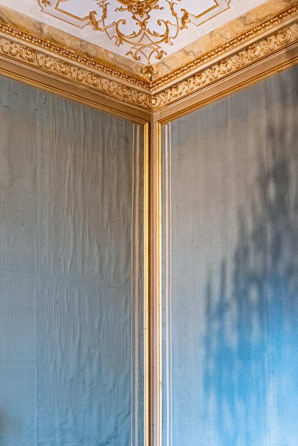 a room with blue walls and a gold ceiling