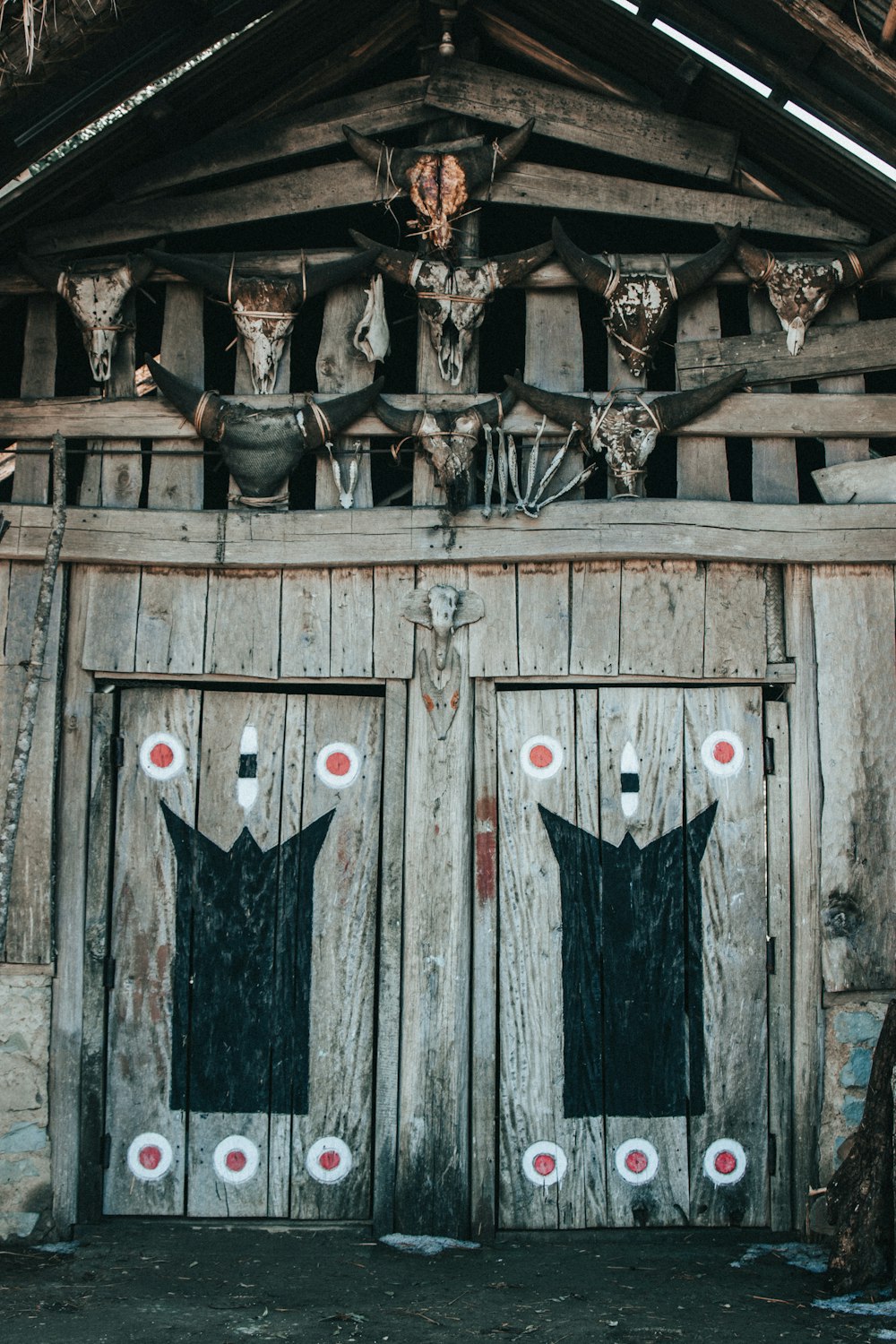 two wooden doors with deer heads on them