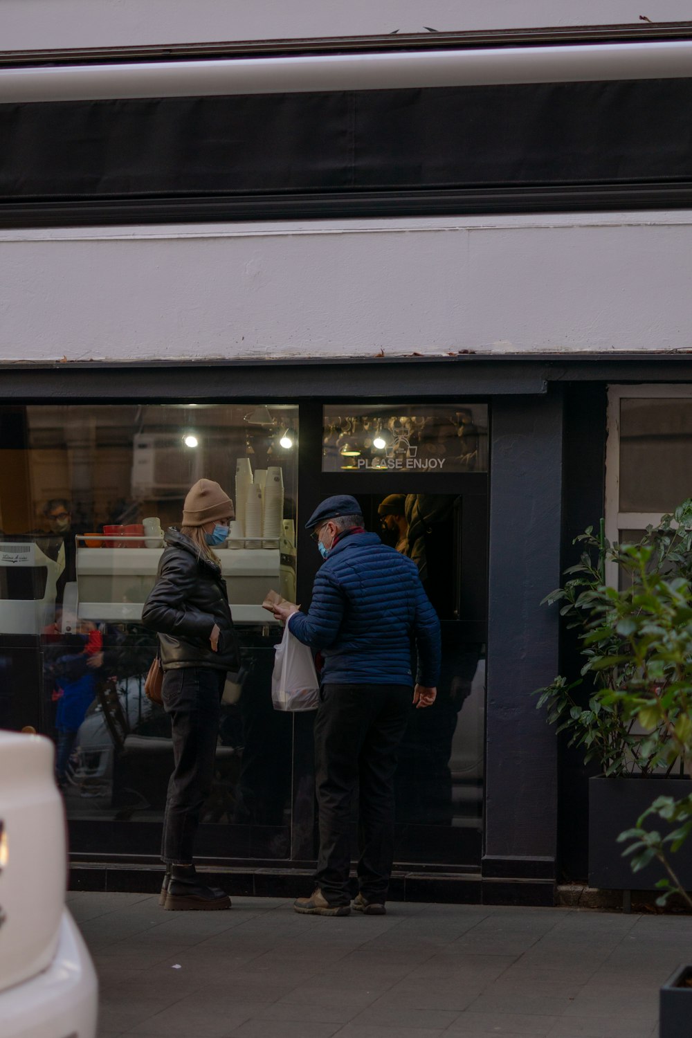 a couple of people standing outside of a building