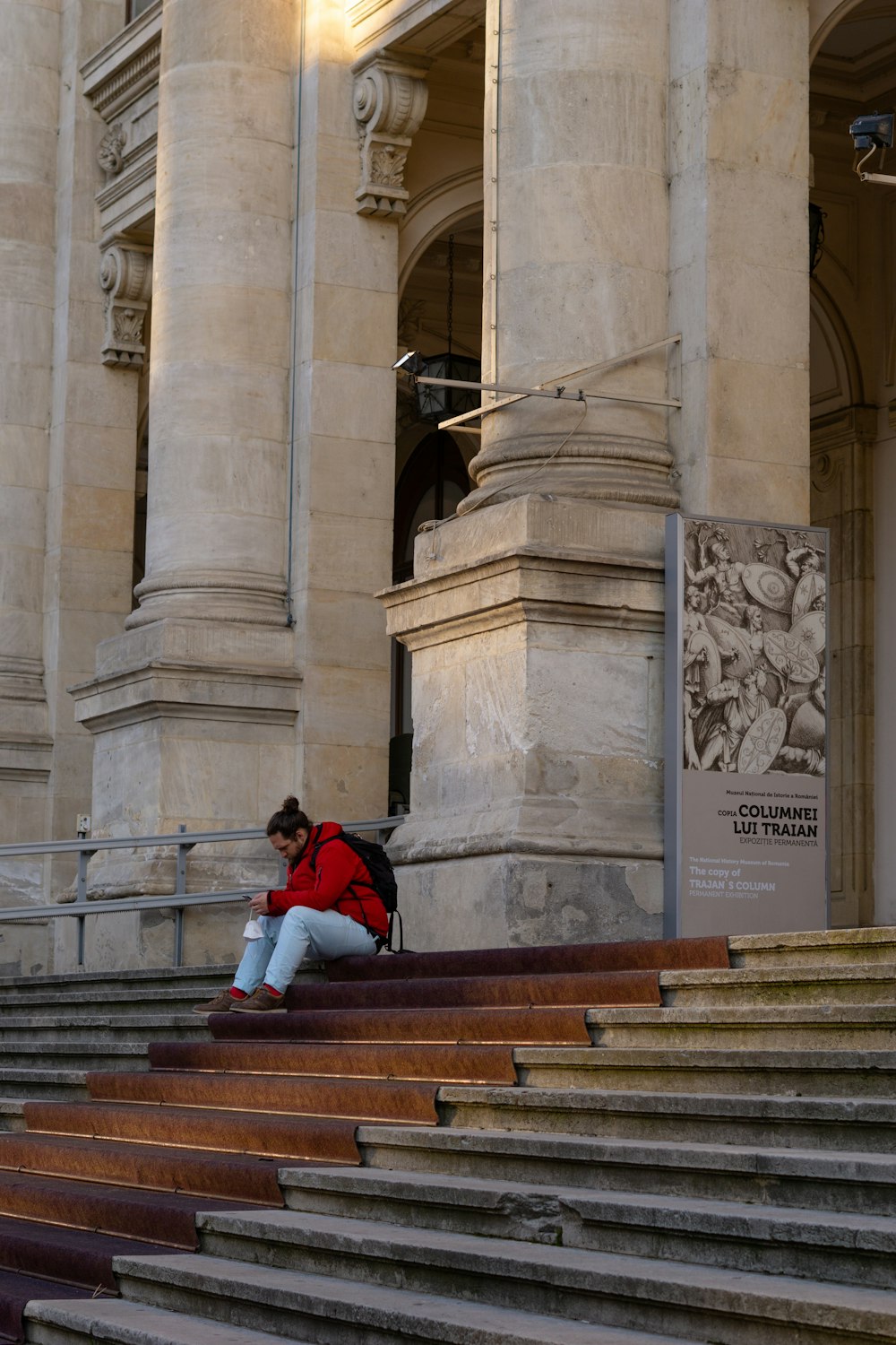 a person sitting on some steps in front of a building