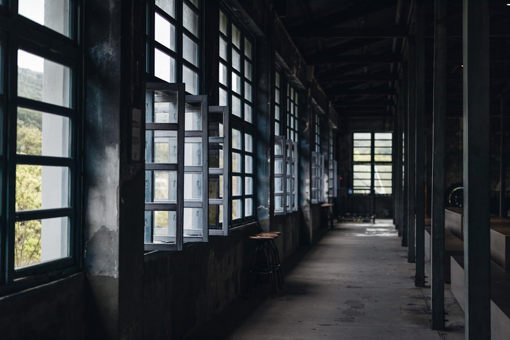 a long hallway with several windows and a bench