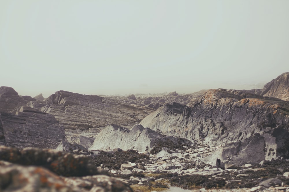 a man standing on top of a rocky hillside