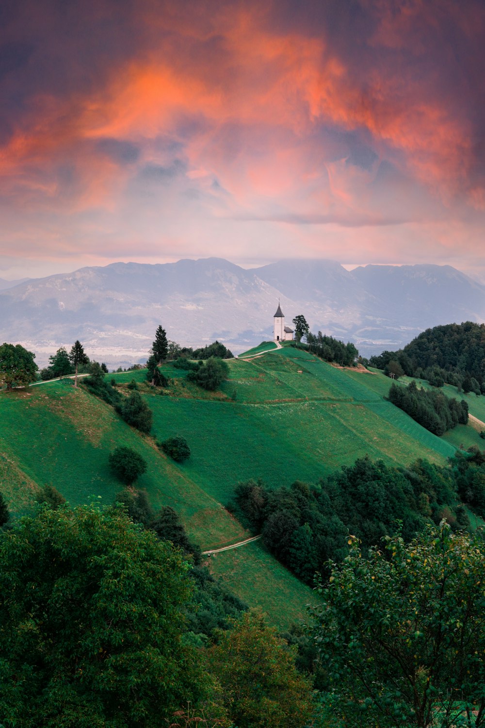 a green hill with a church on top of it