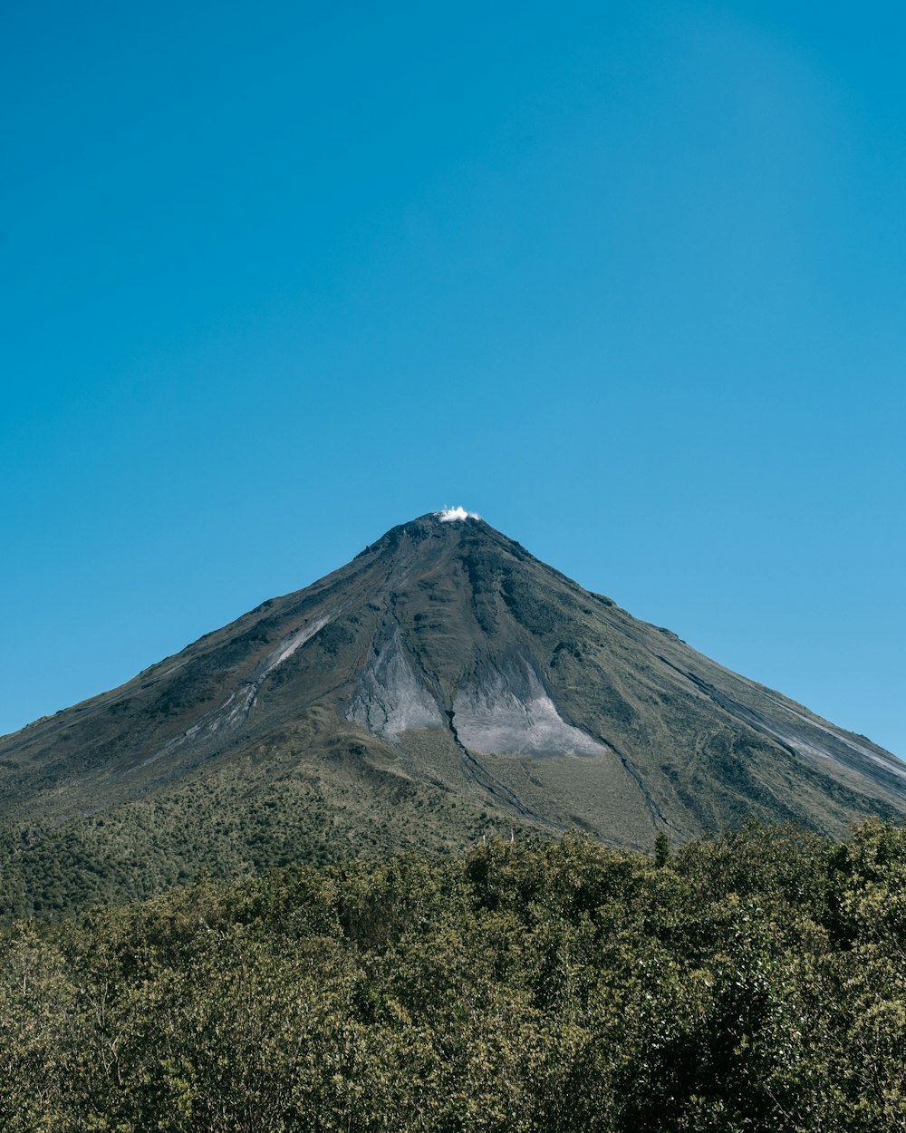 a mountain with a snow capped peak in the distance