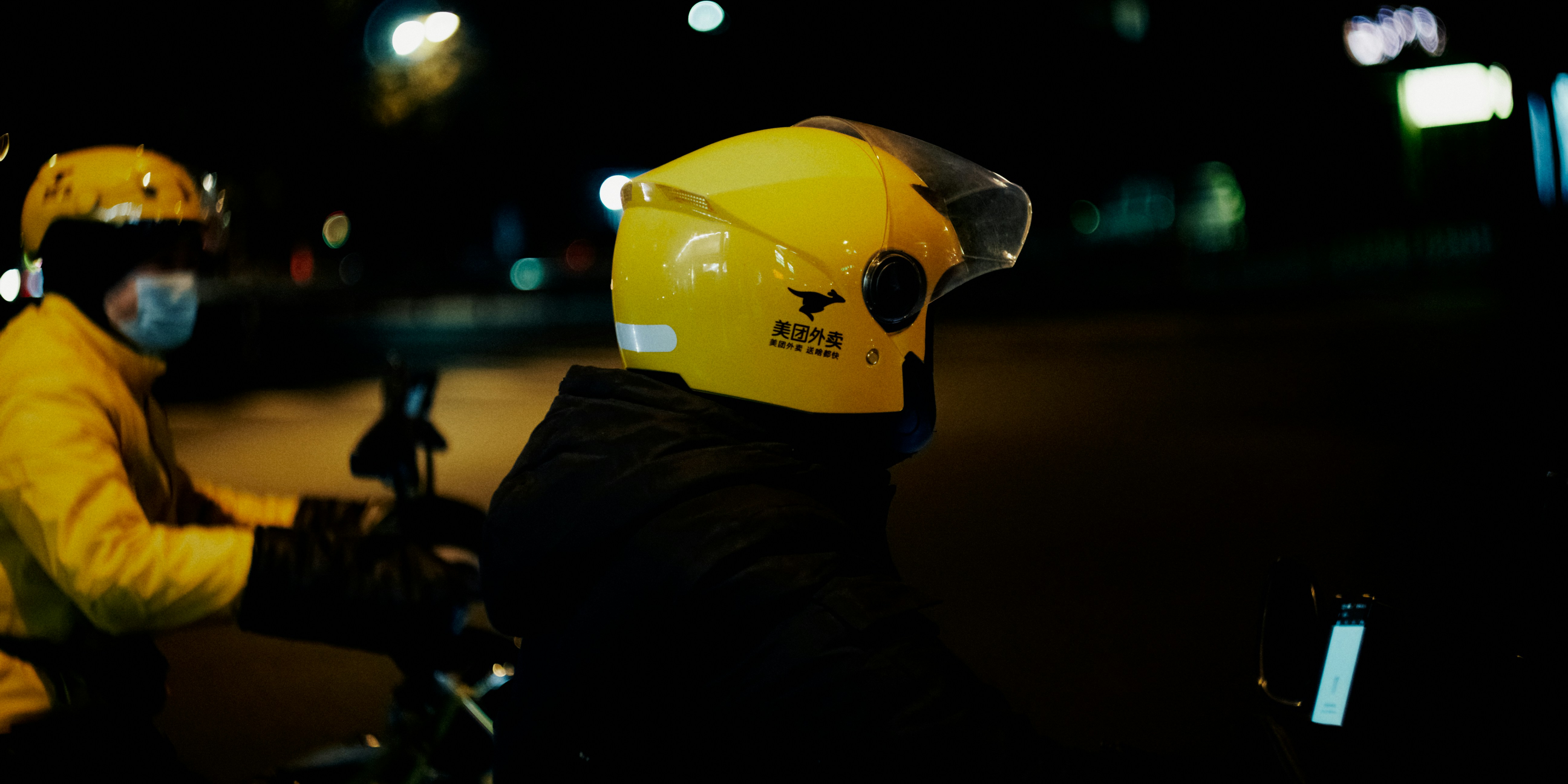 a couple of people riding on the back of a motorcycle