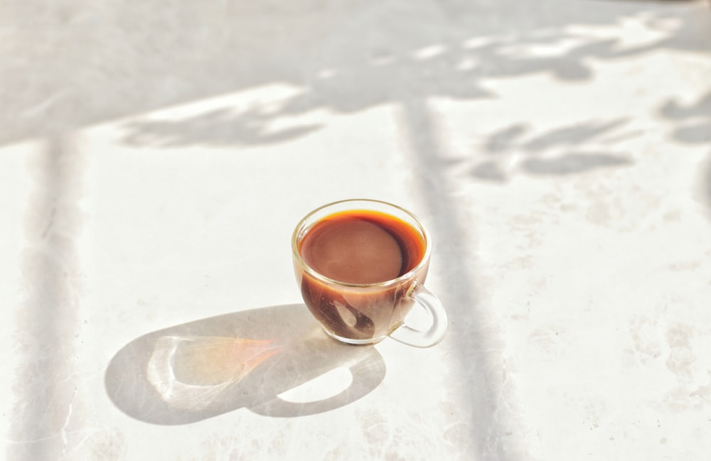 a cup of coffee sitting on top of a table