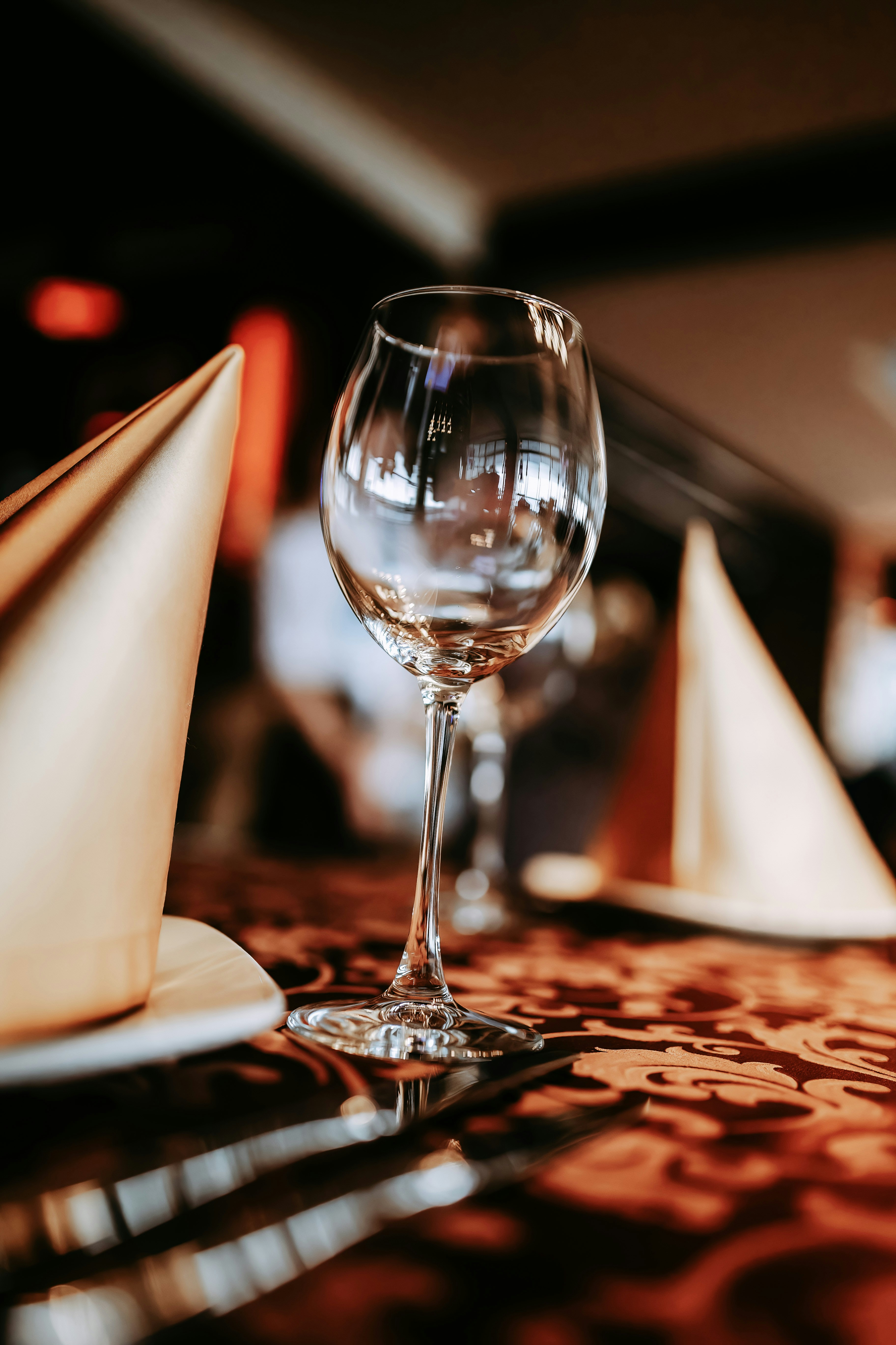 a glass of wine sitting on top of a table