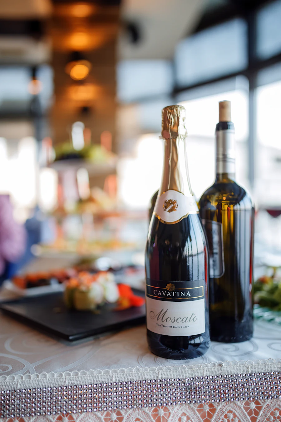 Wine bottles on a table in a dimly lit dining room