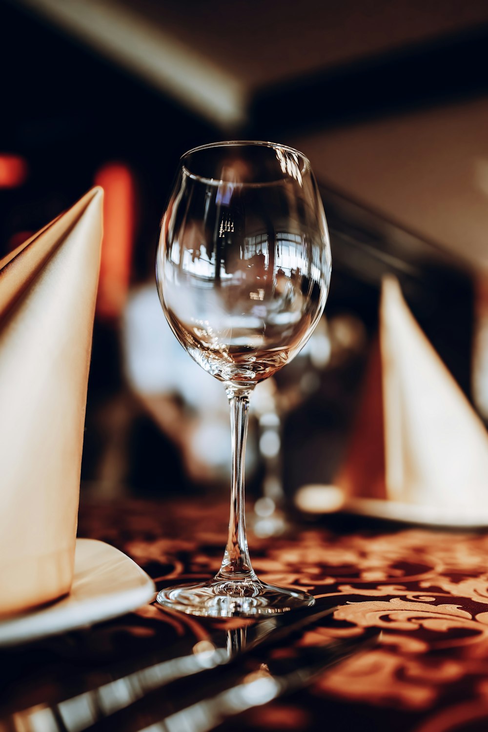 a glass of wine sitting on top of a table