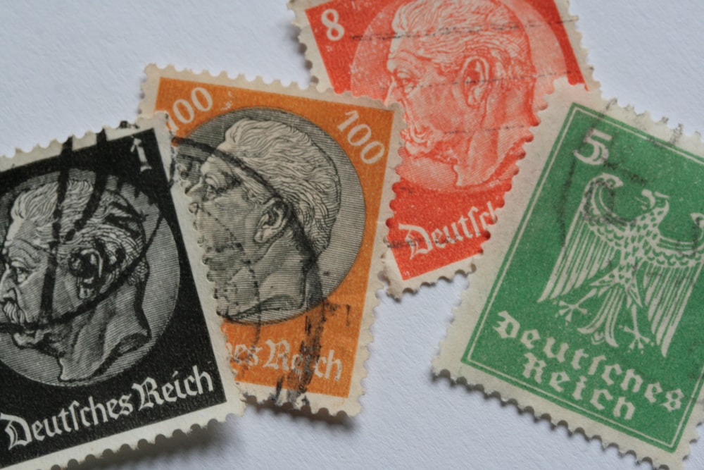 a group of three different colored stamps on a white surface