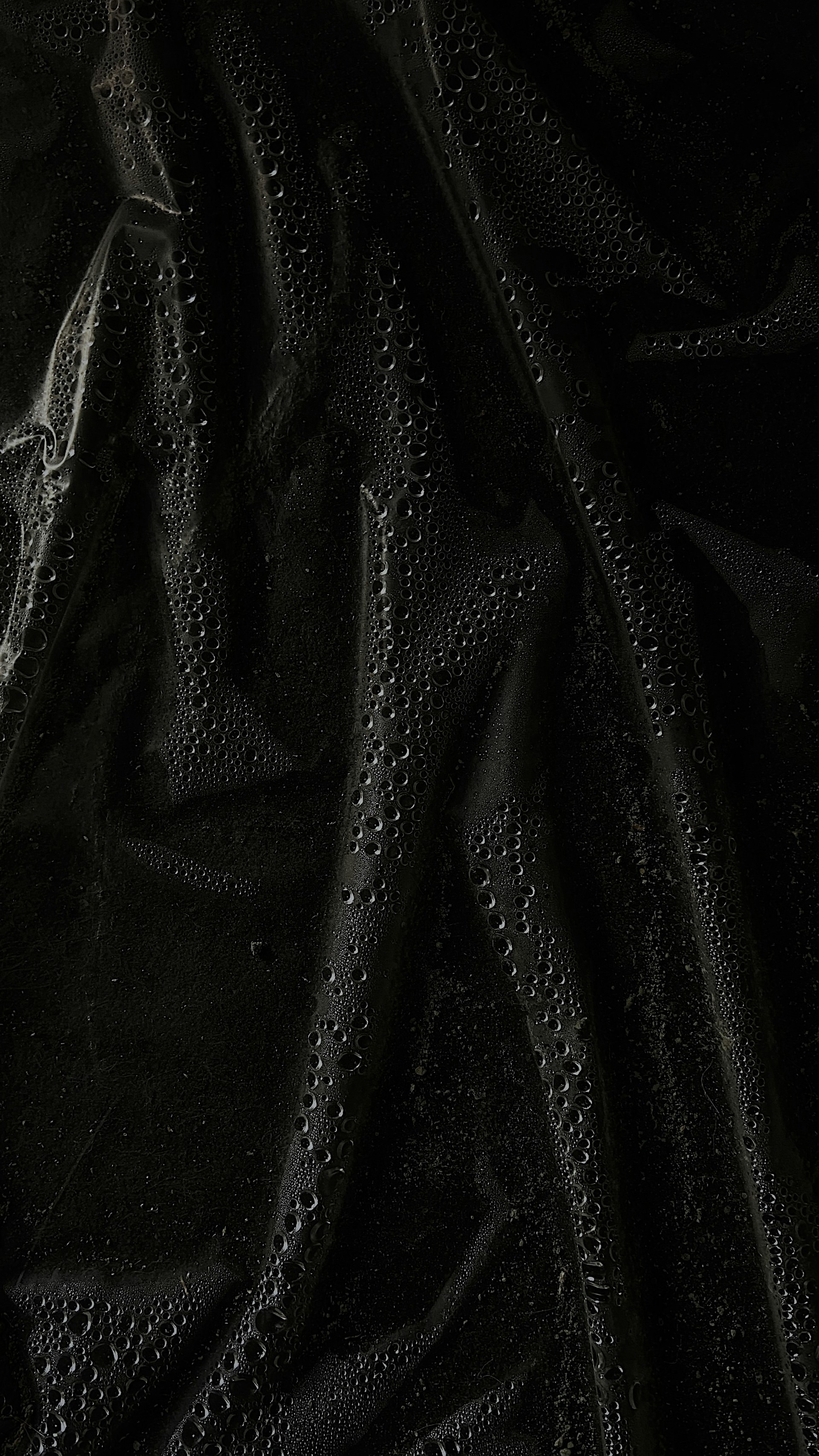 a black cloth with water drops on it